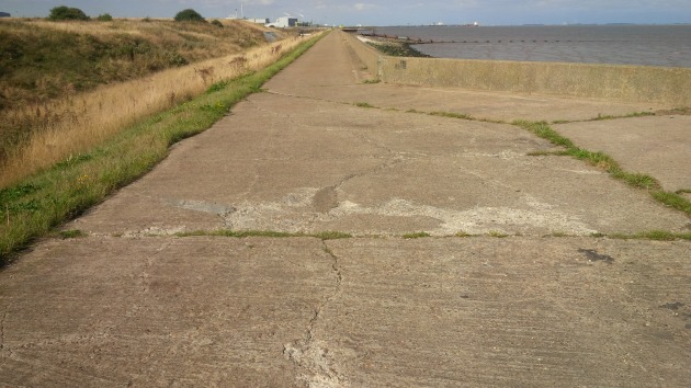 A section of the sea wall, showing the rutted and broken surface.