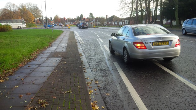 The painted on cycle lane goes straight on, forcing traffic turning left to cross it.